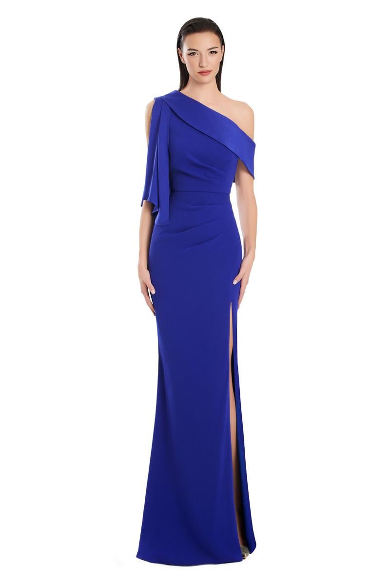 Model wearing Alexander by Daymor 3058S25 one-shoulder draped evening gown with pleated bodice, high side slit, and cascading detail.