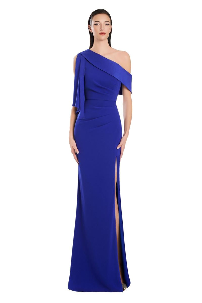 Model wearing Alexander by Daymor 3058S25 one-shoulder draped evening gown with pleated bodice, high side slit, and cascading detail.