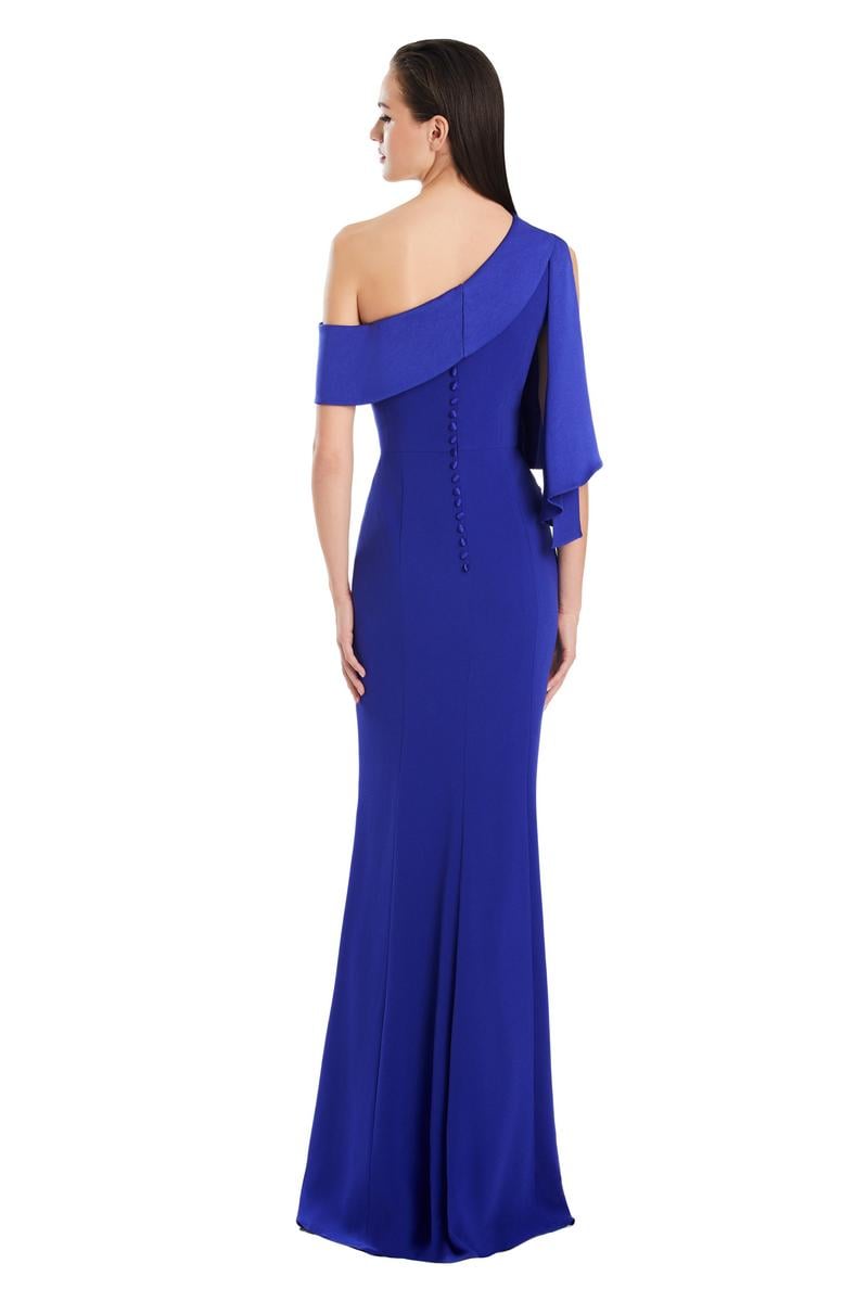 Model wearing Alexander by Daymor 3058S25 one-shoulder draped evening gown with pleated bodice, high side slit, and cascading detail.
