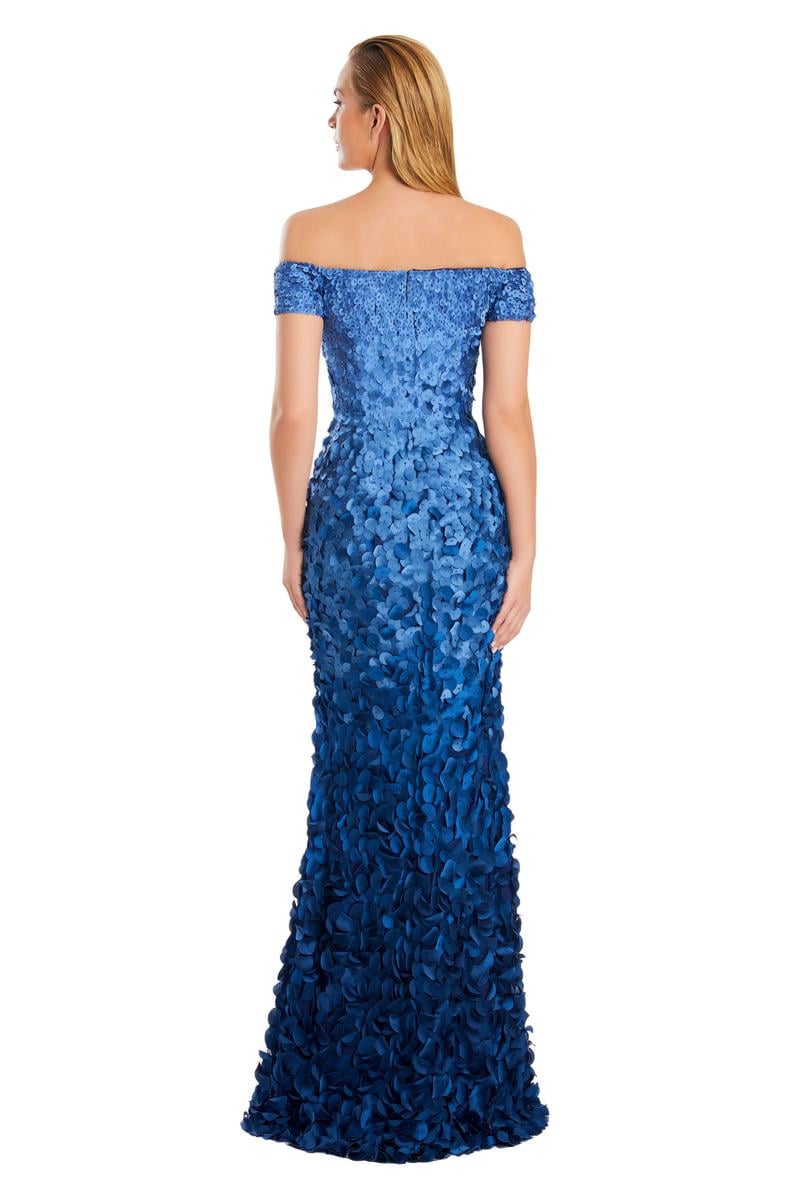 Model wearing Alexander by Daymor 3063S25 off-the-shoulder gown with floral appliqué detailing, fitted silhouette, and floor-length skirt.