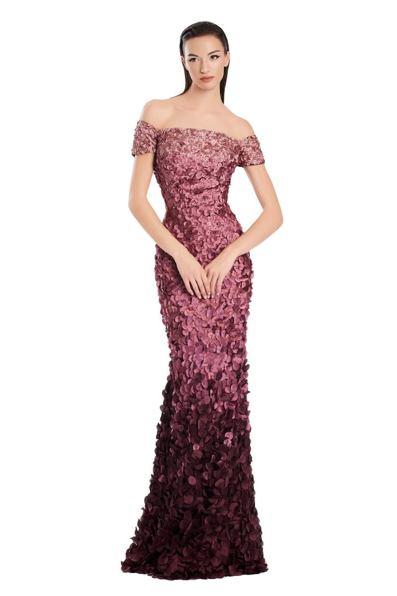 Model wearing Alexander by Daymor 3063S25 off-the-shoulder gown with floral appliqué detailing, fitted silhouette, and floor-length skirt.