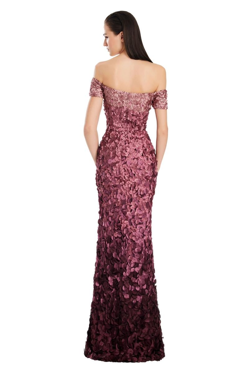 Model wearing Alexander by Daymor 3063S25 off-the-shoulder gown with floral appliqué detailing, fitted silhouette, and floor-length skirt.