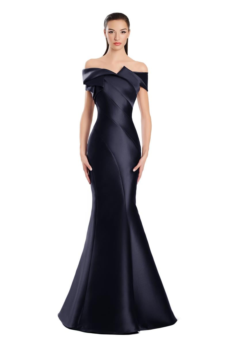 Model wearing Alexander By Daymor 3079CS25 evening gown featuring an off-the-shoulder pleated neckline and flared hemline.