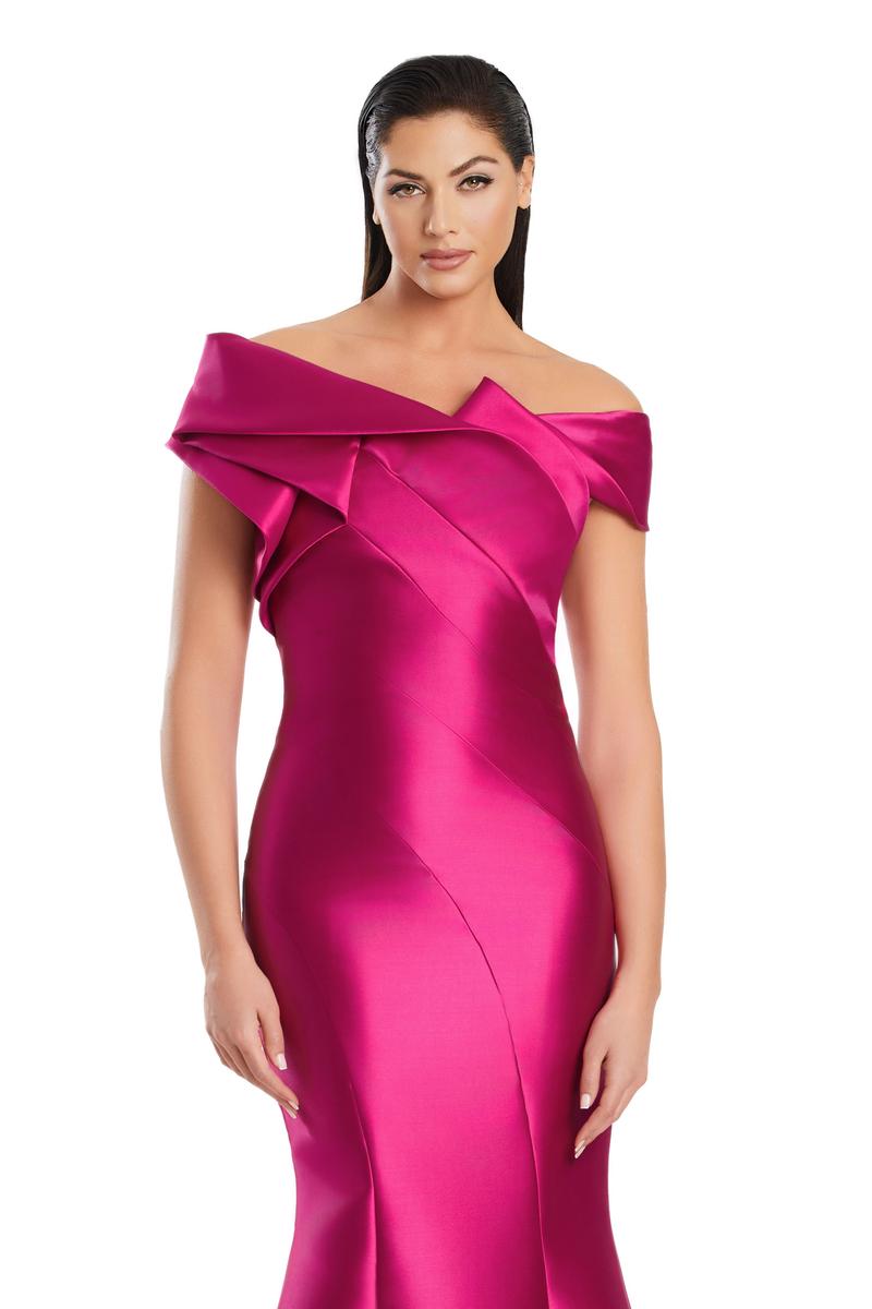 Model wearing Alexander By Daymor 3079CS25 evening gown featuring an off-the-shoulder pleated neckline and flared hemline.