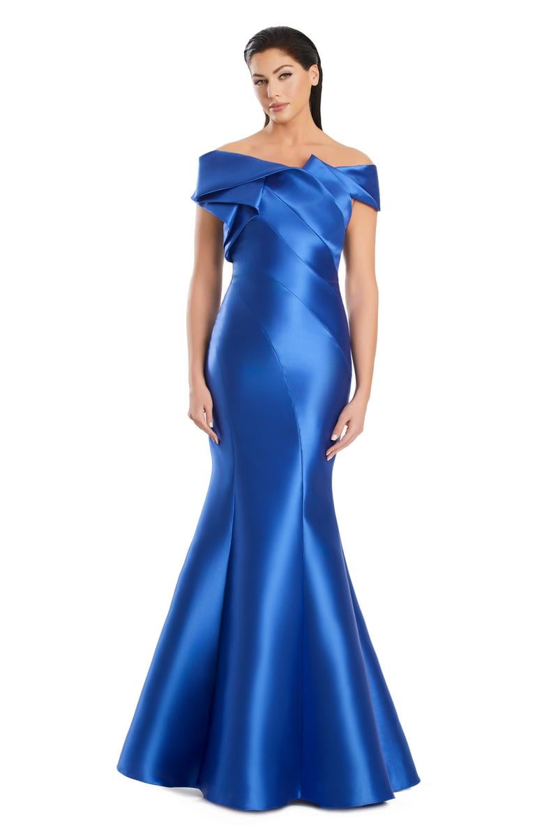 Model wearing Alexander By Daymor 3079CS25 evening gown featuring an off-the-shoulder pleated neckline and flared hemline.