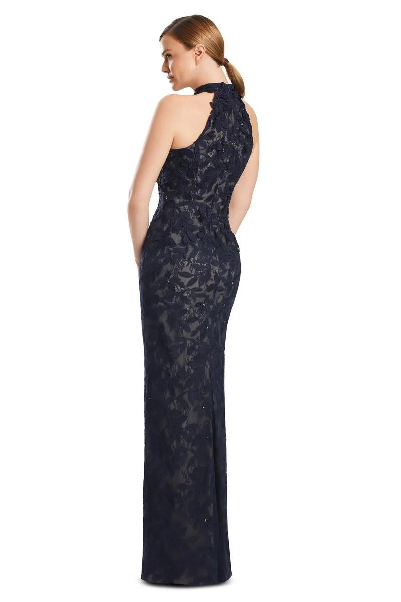 Woman wearing a dark navy blue lace evening gown on a white background