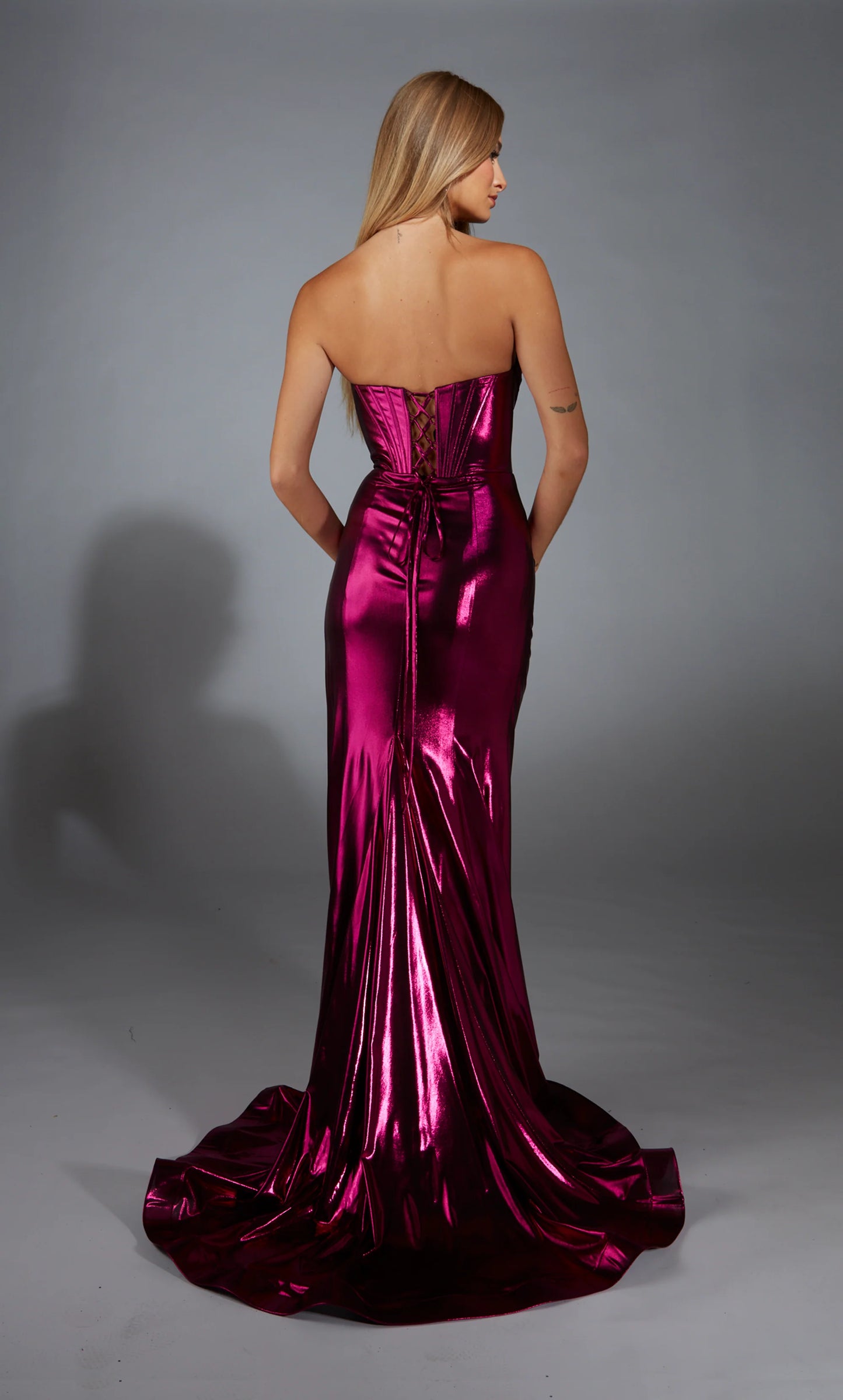 Alyce Paris 61798 Metallic Foil Corset Gown in fuchsia featuring a corset bodice, metallic foil fabric, thigh-high slit, and lace-up back. Ideal for prom and evening occasions. Back View.