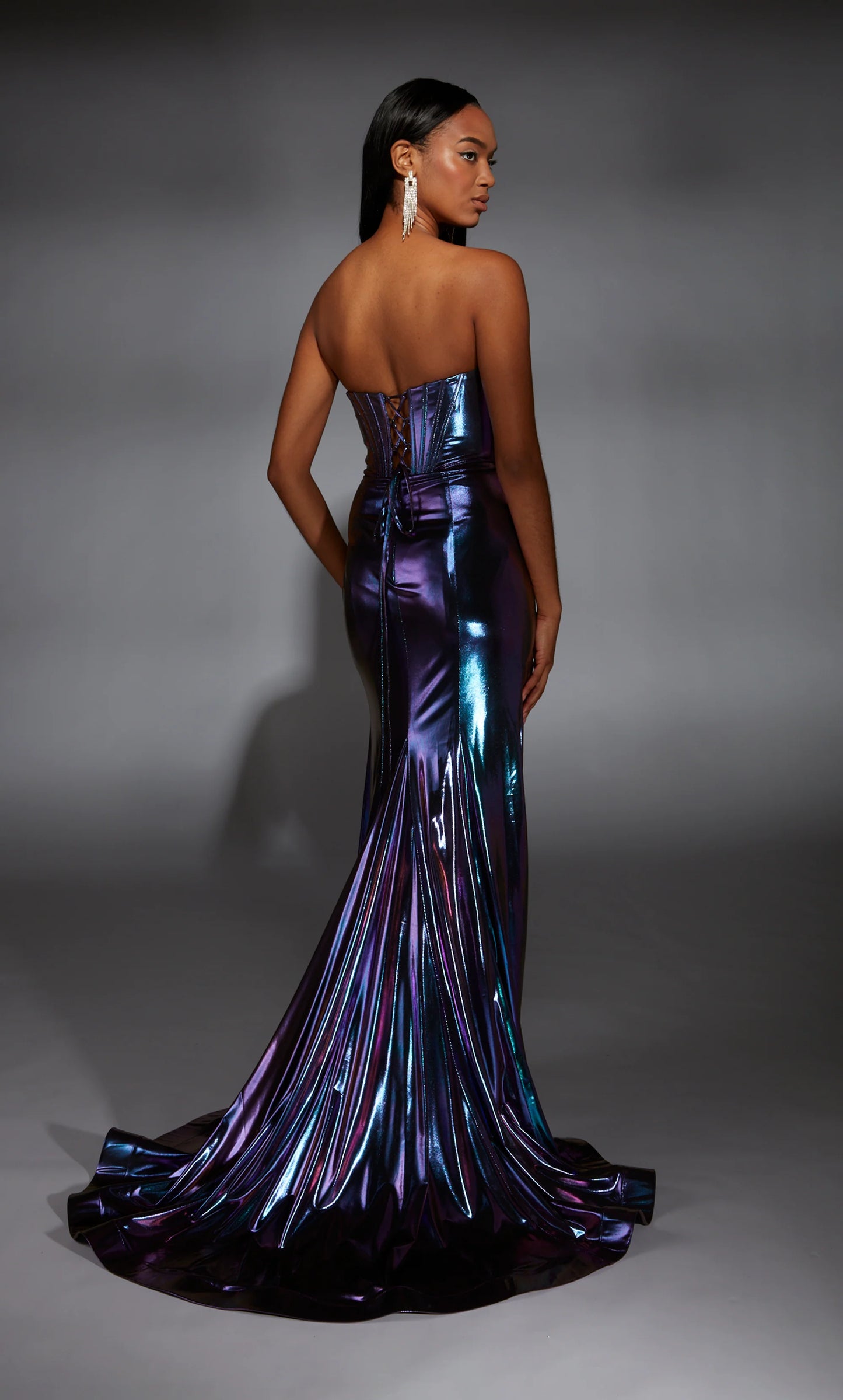 Alyce Paris 61798 Metallic Foil Corset Gown in purple featuring a corset bodice, metallic foil fabric, thigh-high slit, and lace-up back. Ideal for prom and evening occasions. Model is wearing the color purple. Back View.