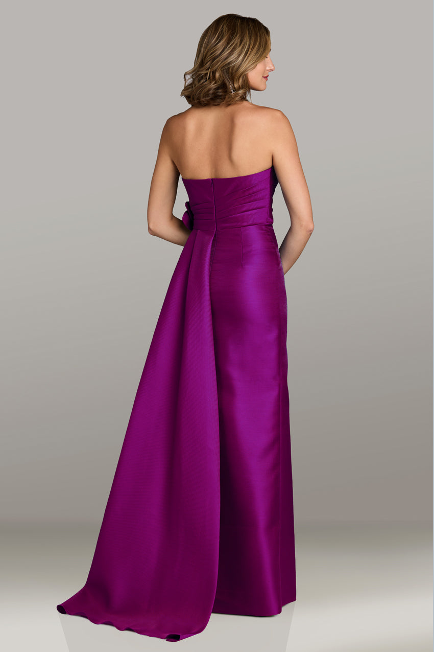 Gia Franco 12549 strapless gown in magenta featuring a draped bow accent and a side train, perfect for formal evenings and Mother of the Bride or Groom occasions.