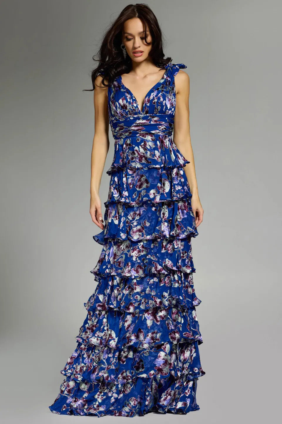 Jovani 42381 Ruffled Floral Gown featuring cascading ruffled tiers, floral print, plunging neckline, and shoulder ties for formal occasions.