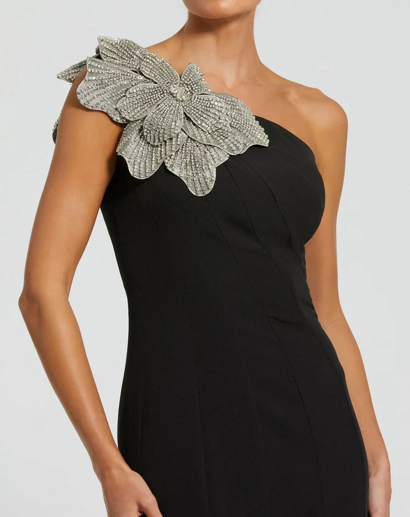 Model wearing Mac Duggal 11810 one-shoulder trumpet gown with flower detail.