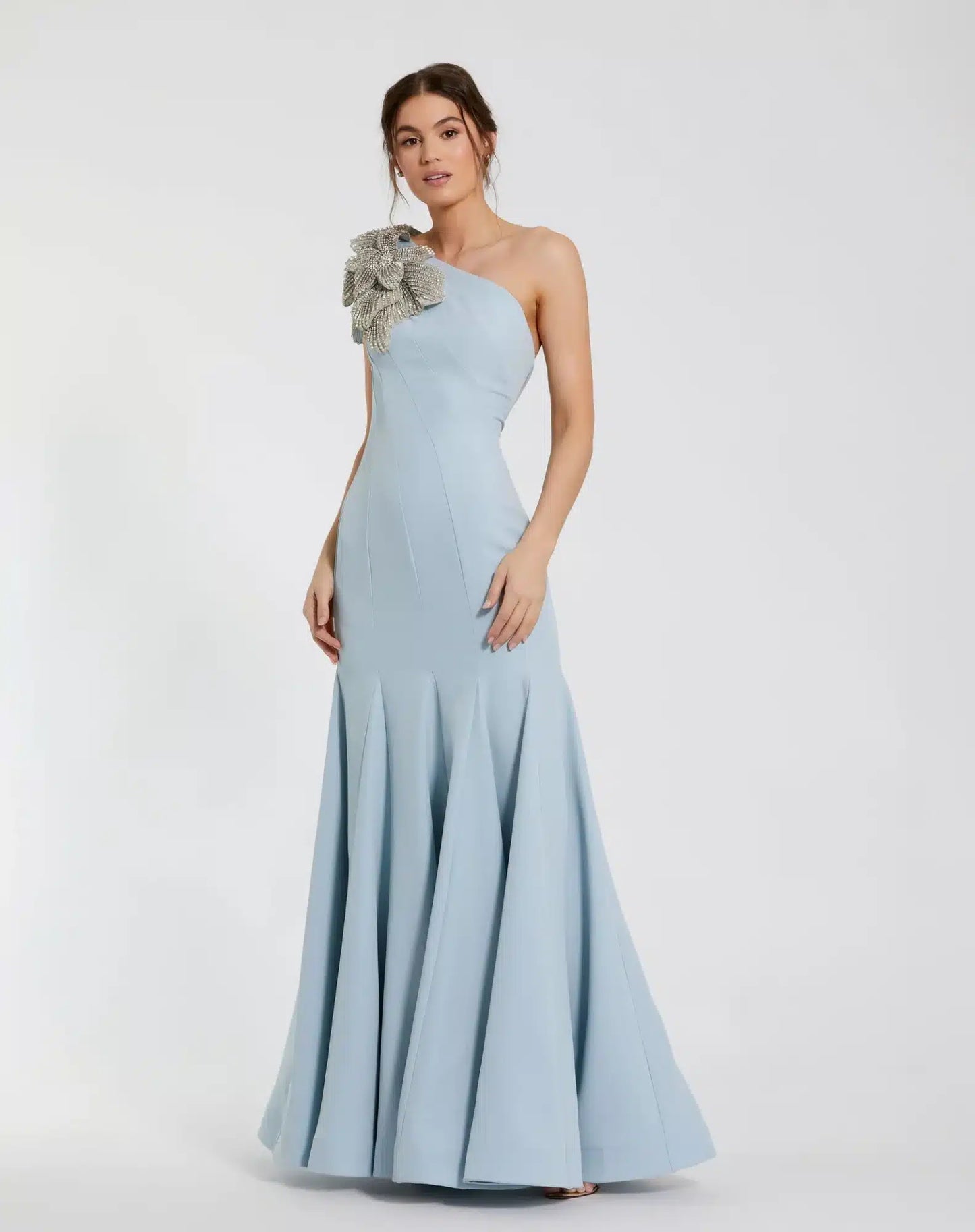 Model wearing Mac Duggal 11810 one-shoulder trumpet gown with flower detail. Model wearing the dress in the color powder blue. Front view.