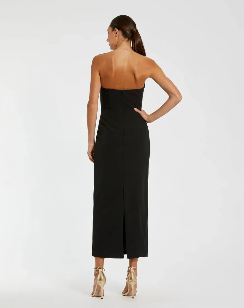 Model wearing Mac Duggal 2283 strapless crepe gown with 3D satin floral appliqués and back slit. Back View of the dress.