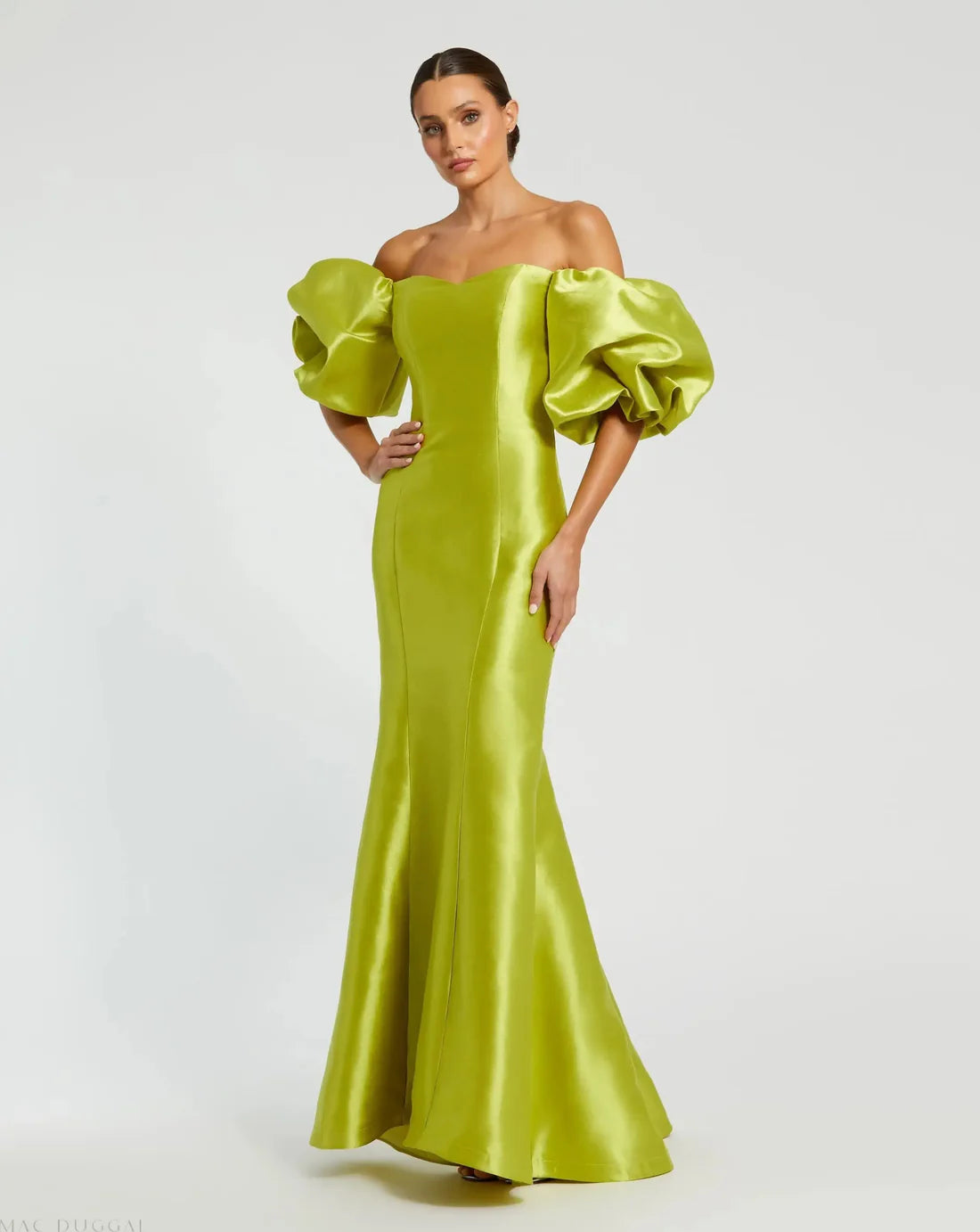 Model wearing Mac Duggal 50677 off-the-shoulder satin gown with puff sleeves, mermaid silhouette, and sweeping train. Model is wearing the color chartreuse. Front view.