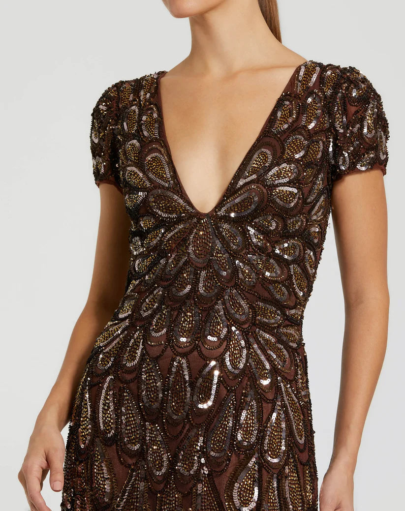 Model wearing Mac Duggal 5243 evening gown with deep V-neckline, cap sleeves, and hand-beaded sequin teardrop pattern. Close up picture.