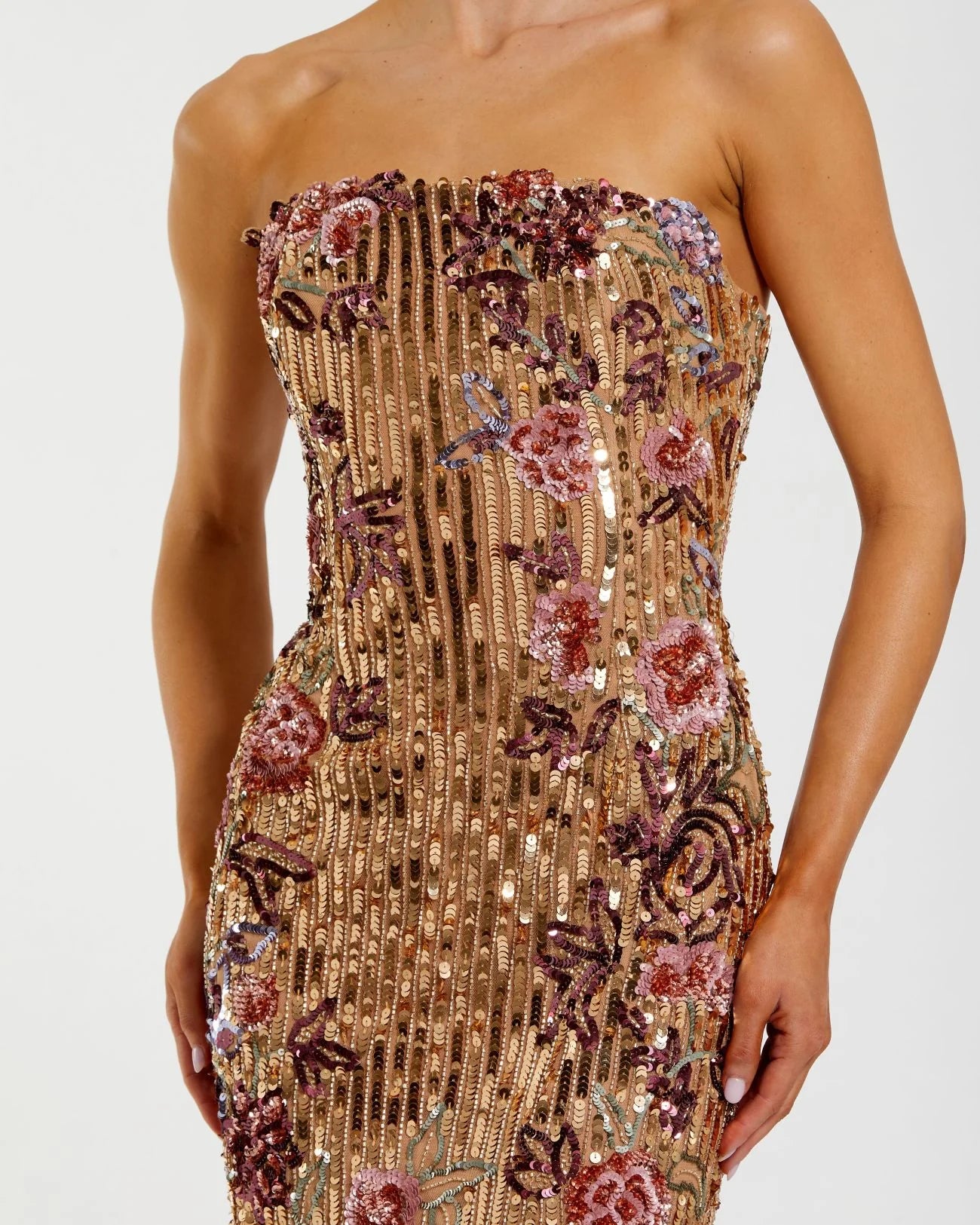 Model wearing Mac Duggal 6193 strapless floral sequin column dress with back slit and allover sequin embellishments. Close up of the dresses details.