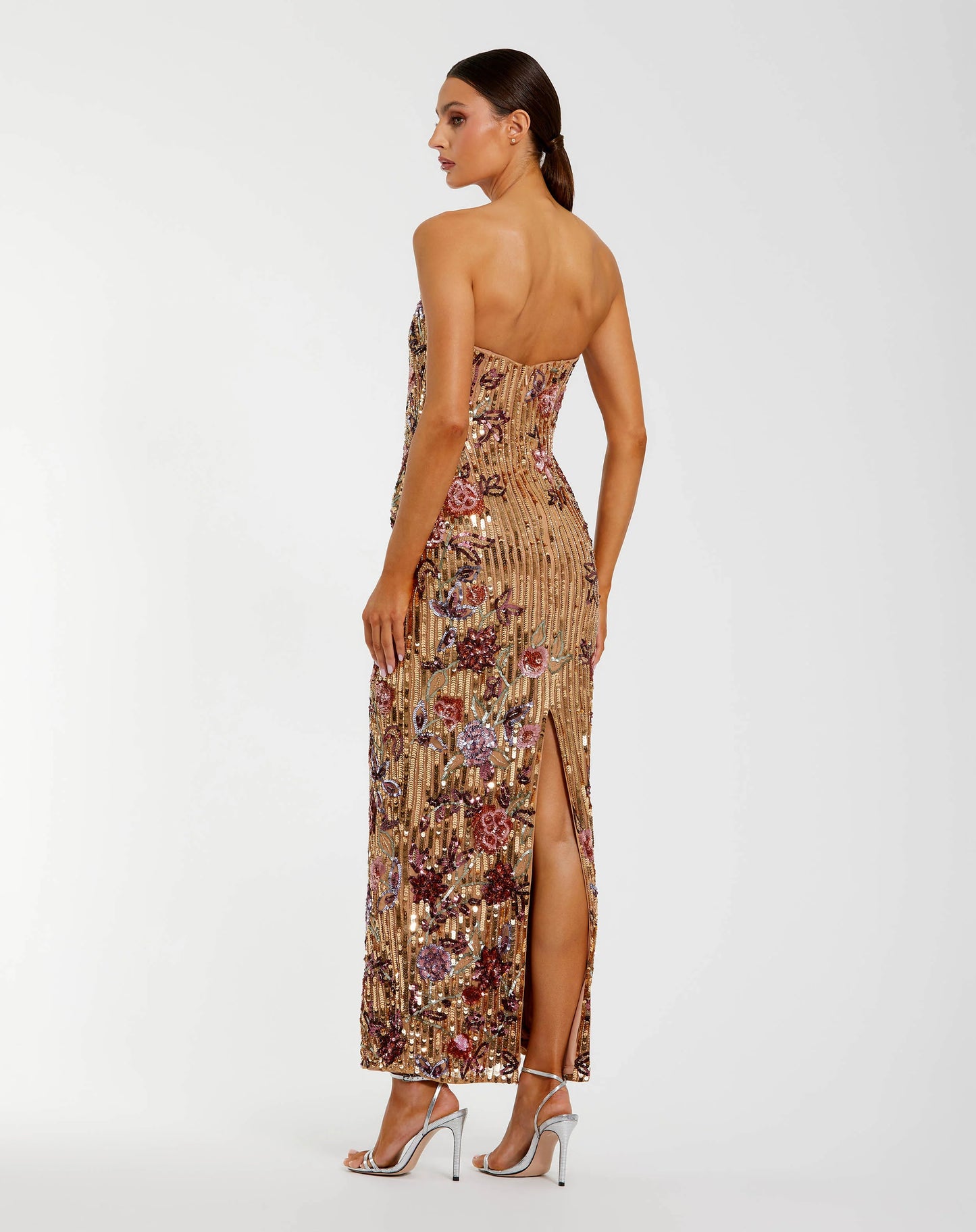 Model wearing Mac Duggal 6193 strapless floral sequin column dress with back slit and allover sequin embellishments. Back View.