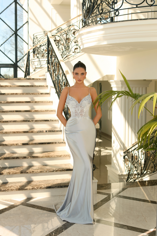 Nicoletta NC1030 Chantilly Lace Inspired Evening Gown - A stunning evening gown featuring a v-neckline, chantilly lace-inspired bodice adorned in intricate beads, and a graceful sweep train.