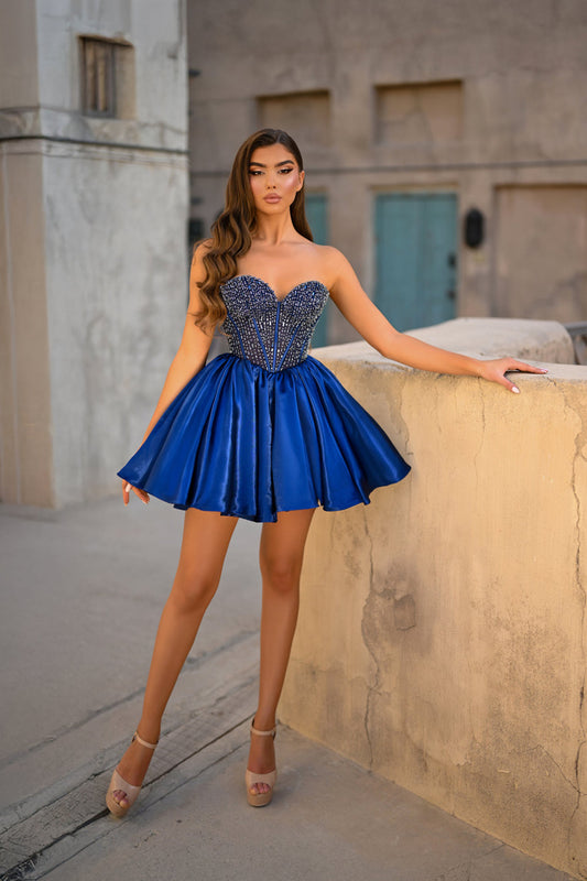 Model wearing Portia & Scarlett PS25711 strapless crystal corset skater dress with a flared mini skirt.
