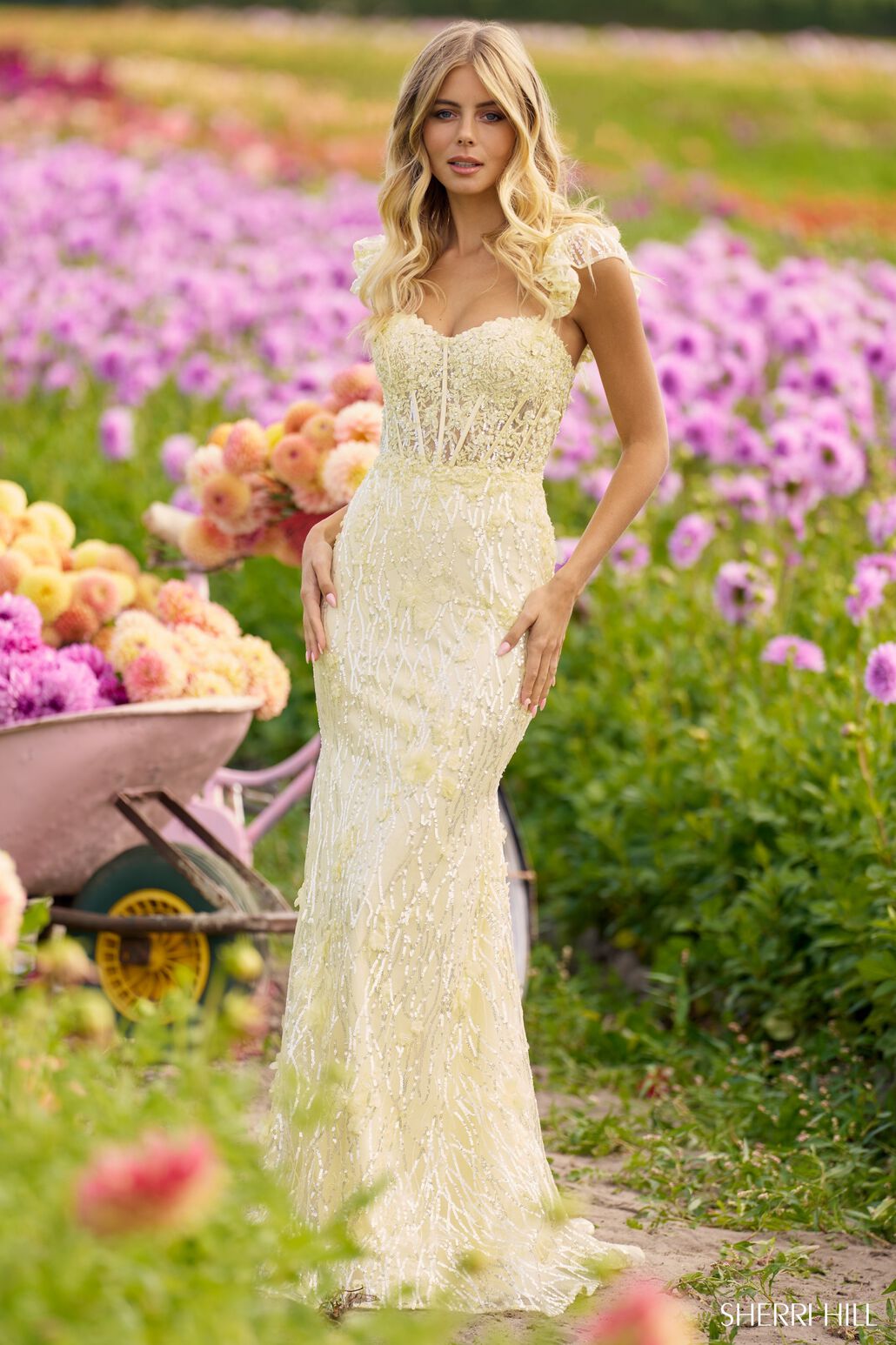 The Sherri Hill Sequin Lace Fitted Gown, a captivating choice with a corset bodice, ruffle sleeves, and a lace-up back. Ideal for proms and formal events.