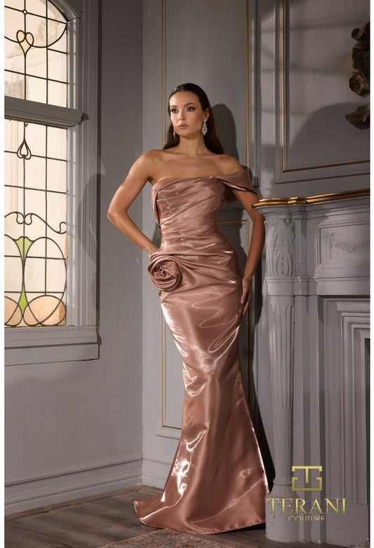 Model wearing Terani 252E5162 off-shoulder gown with draped bodice, rosette detail at hip, and fit-and-flare silhouette.  Model is wearing the color champagne.