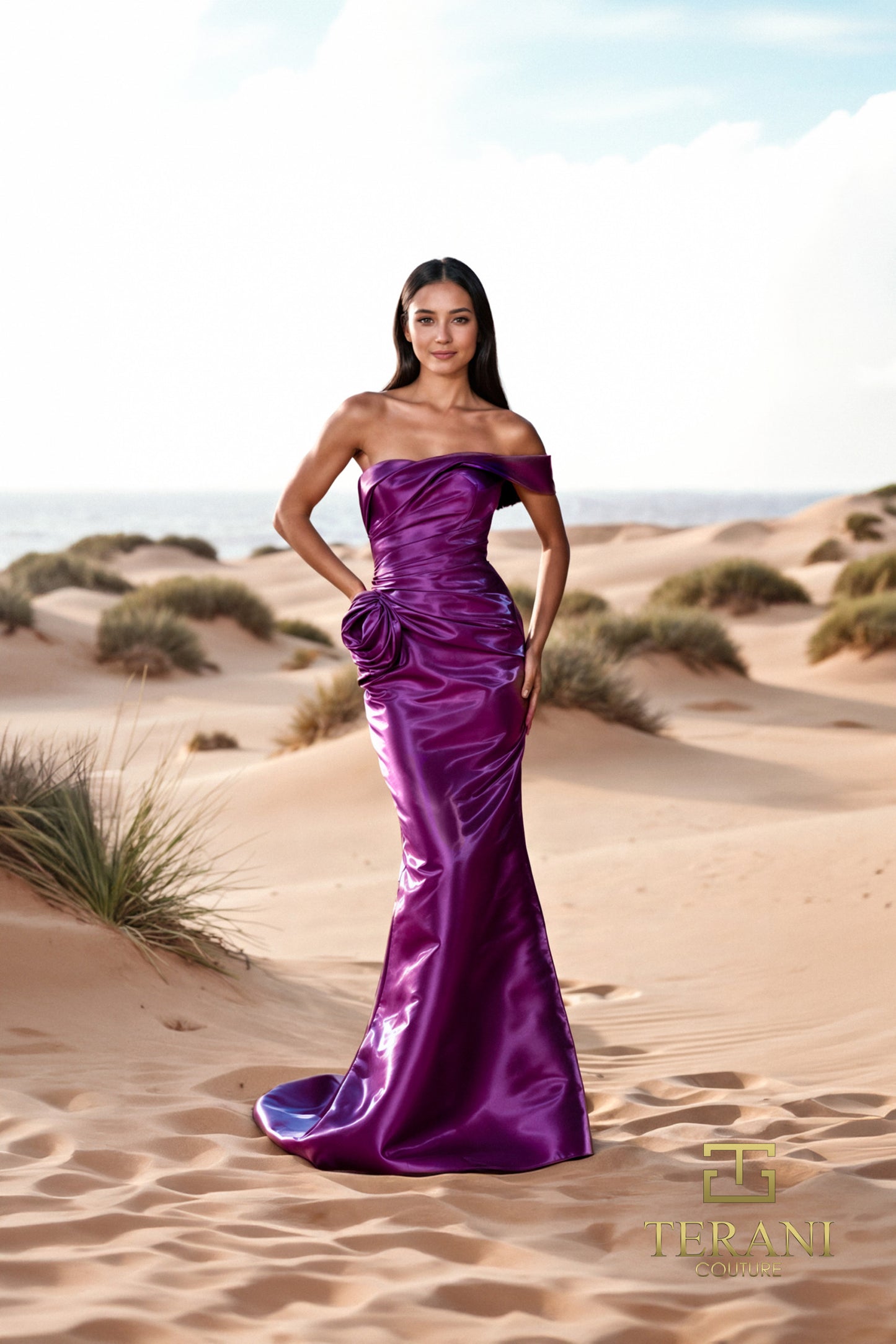 Model wearing Terani 252E5162 off-shoulder gown with draped bodice, rosette detail at hip, and fit-and-flare silhouette. Model is wearing the color plum.