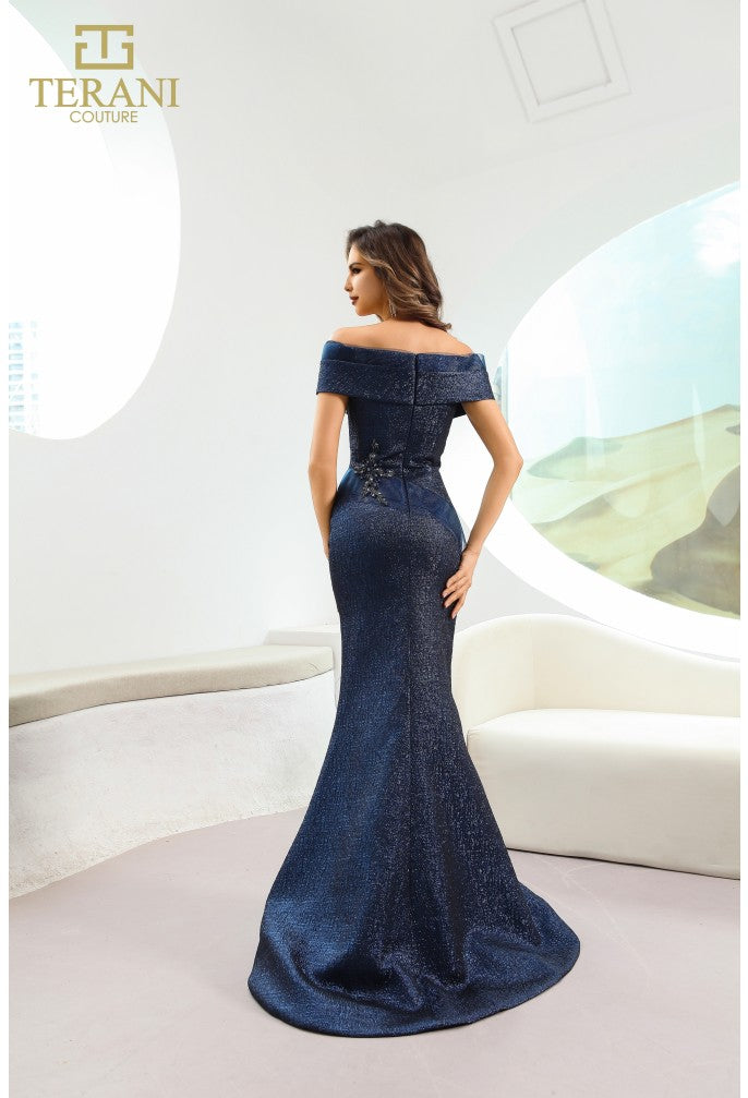 Model wearing Terani Couture 241M2771 off-the-shoulder beaded trumpet gown with fitted bodice and elegant flared skirt in the color navy.