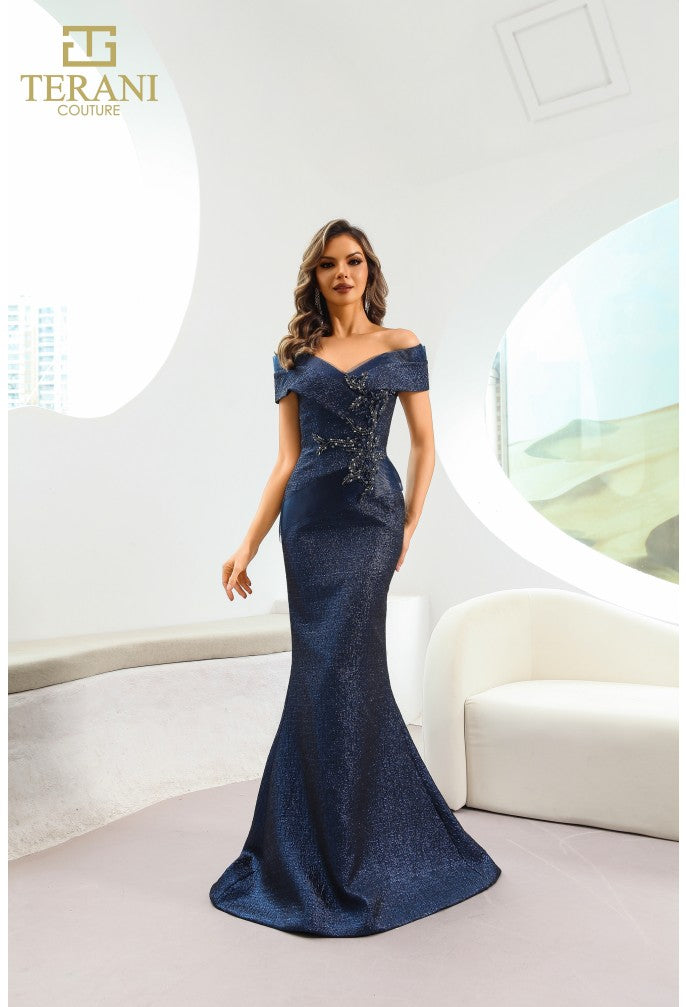Model wearing Terani Couture 241M2771 off-the-shoulder beaded trumpet gown with fitted bodice and elegant flared skirt in the color navy.
