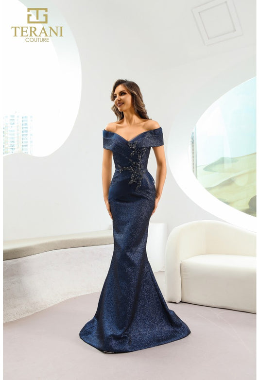 Model wearing Terani Couture 241M2771 off-the-shoulder beaded trumpet gown with fitted bodice and elegant flared skirt in the color navy.