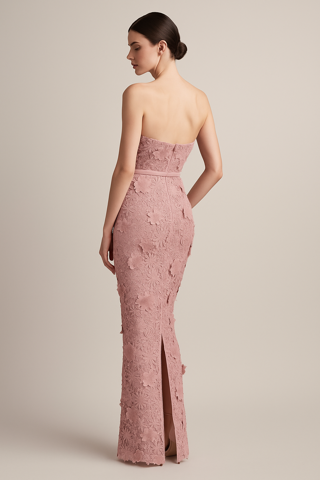 Model wearing Madeline’s Amiri strapless gown featuring 3D floral detailing, fitted silhouette, and slim belt in the color pink/pink.  Back View.