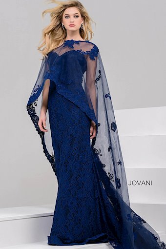 Jovani 39769 Evening Gown with Lace and Sheer Cape Overlay – A floor-length lace gown featuring a high neckline and dramatic sheer cape adorned with floral appliqués.