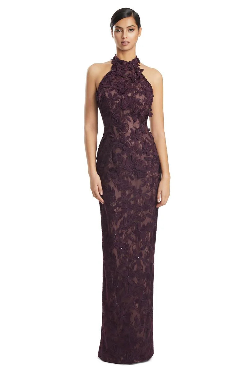 Woman wearing a aubergine lace halter neck gown on a white background