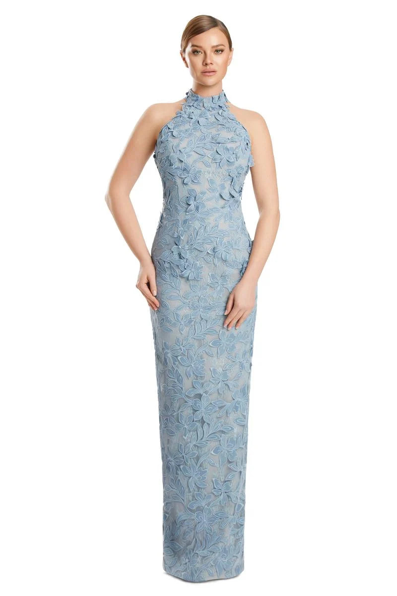 Woman wearing a GLACIER_BLUE lace halter neck gown on a white background