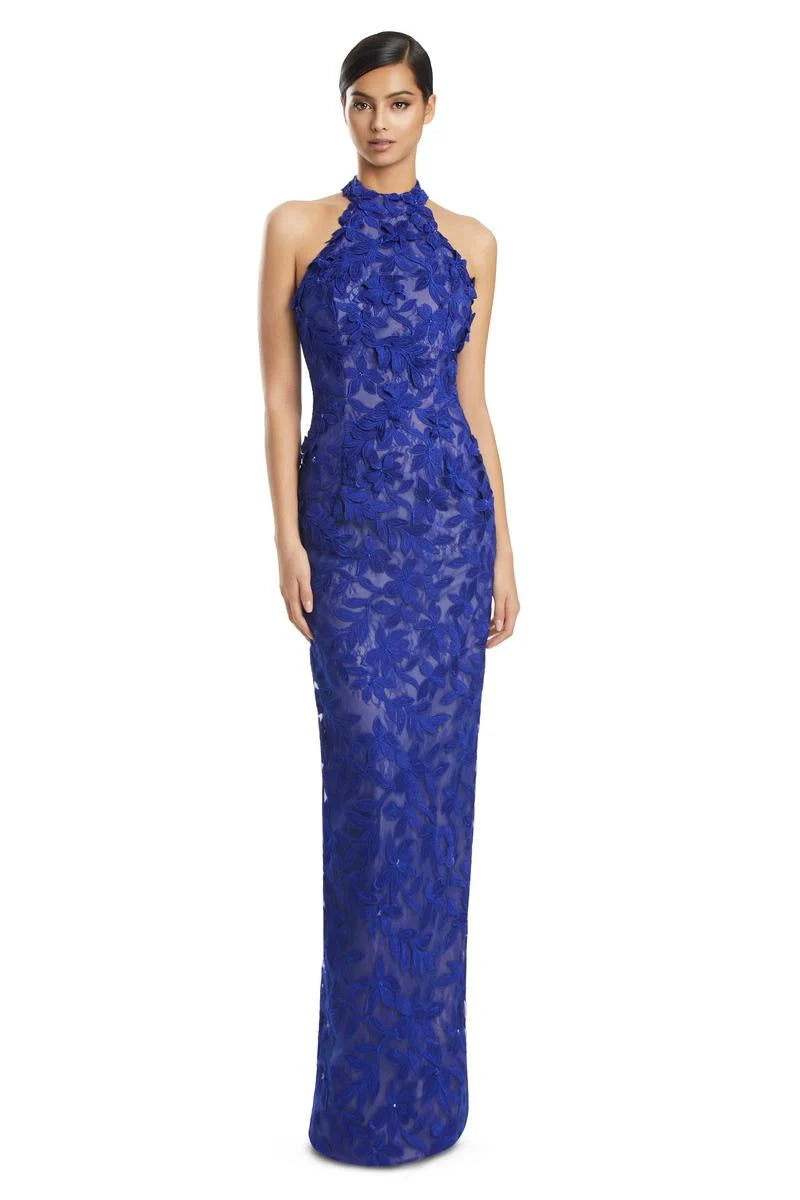 Woman wearing a SAPPHIRE lace evening gown on a white background