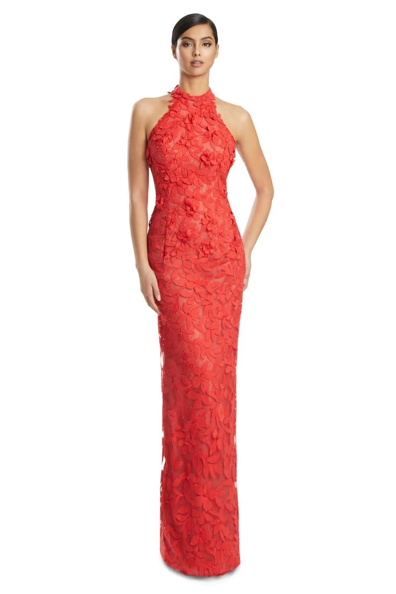 Woman wearing a coral lace halter neck gown on a white background