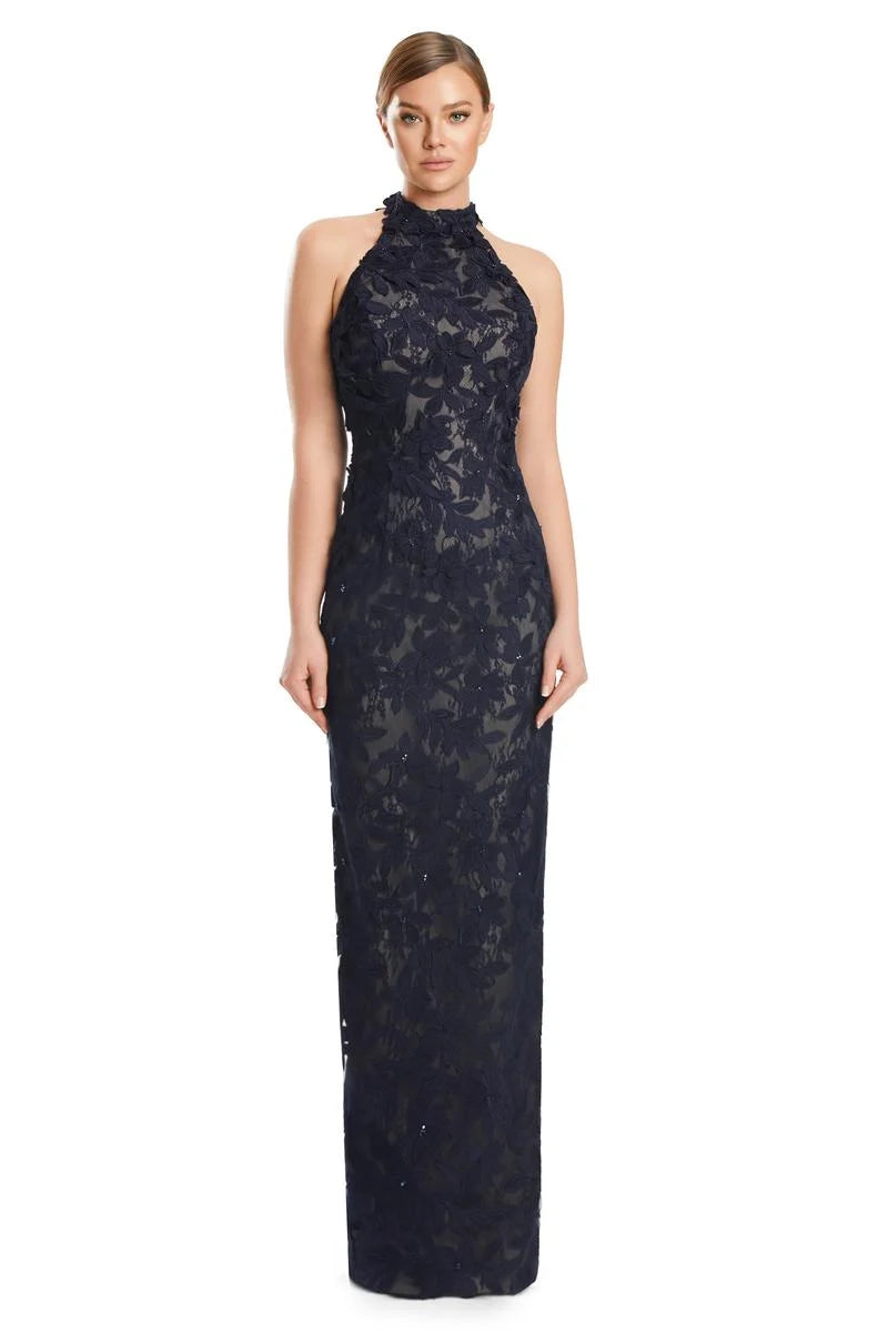 Woman wearing a navy blue lace evening gown on a white background