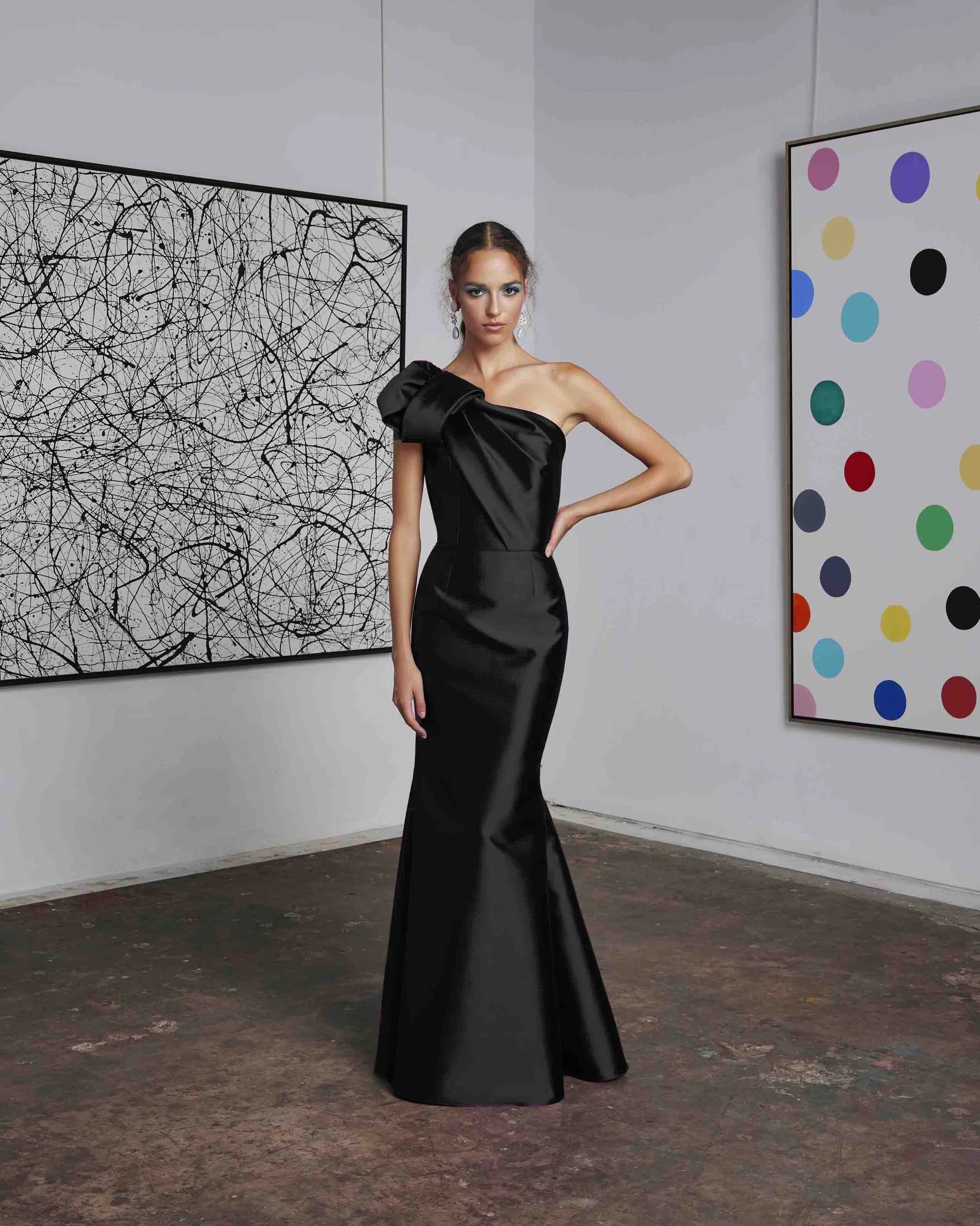Frascara 4612 - A chic one-shoulder evening gown with an asymmetrical bow detail, perfect for formal evenings and mother of the bride or groom occasions.  The model is wearing the dress in black.