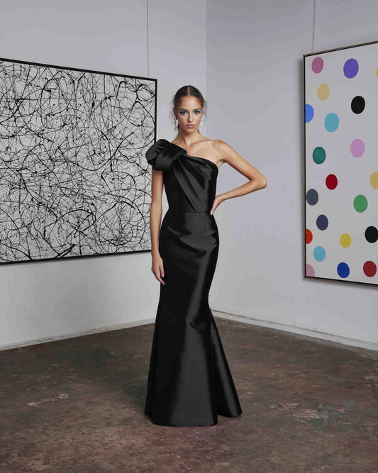Frascara 4612 - A chic one-shoulder evening gown with an asymmetrical bow detail, perfect for formal evenings and mother of the bride or groom occasions.  The model is wearing the dress in black.