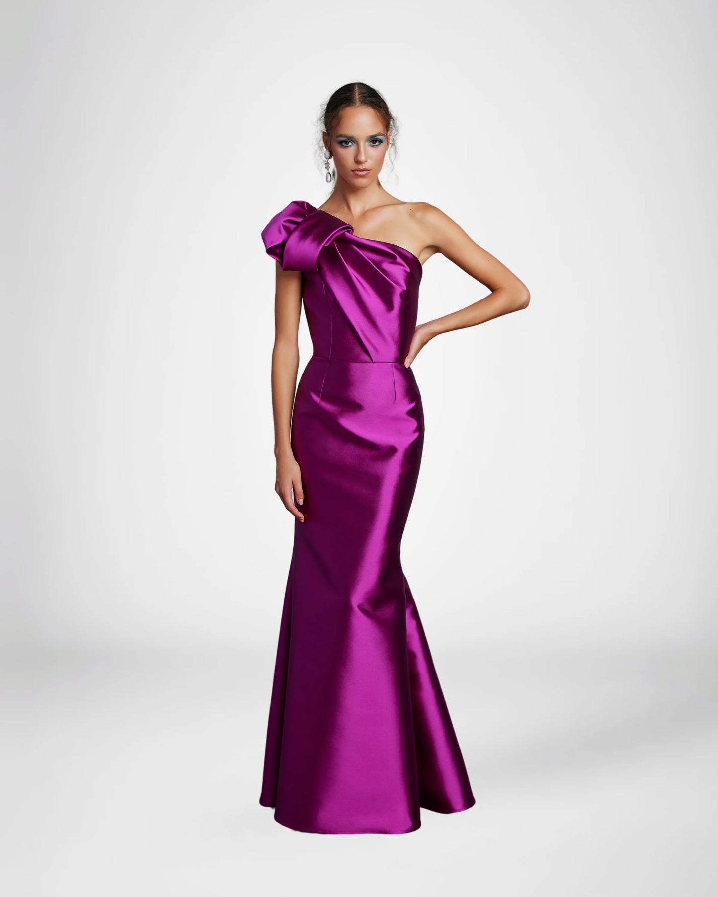 Frascara 4612 - A chic one-shoulder evening gown with an asymmetrical bow detail, perfect for formal evenings and mother of the bride or groom occasions.  The model is wearing the dress in fuchsia. Front view.