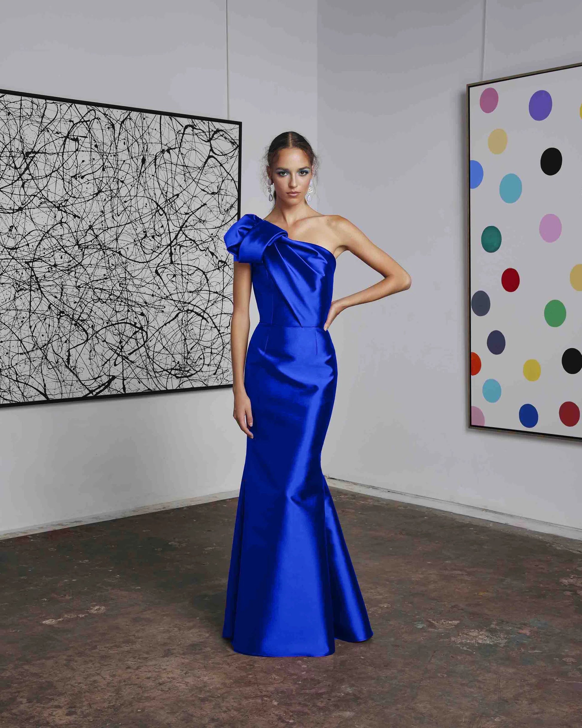 Frascara 4612 - A chic one-shoulder evening gown with an asymmetrical bow detail, perfect for formal evenings and mother of the bride or groom occasions. The model is wearing the dress in fsapphire.