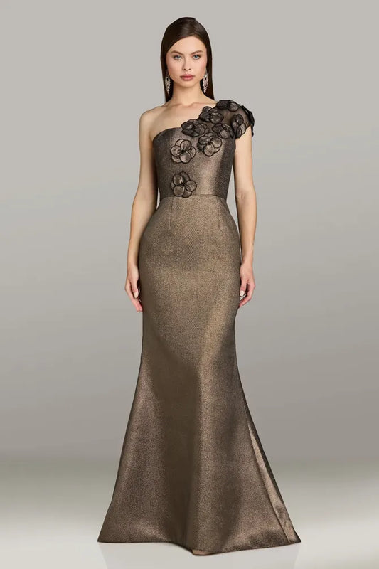 Model wearing Gia Franco 12550 one-shoulder gown with floral appliqué detail and subtle flared hem.