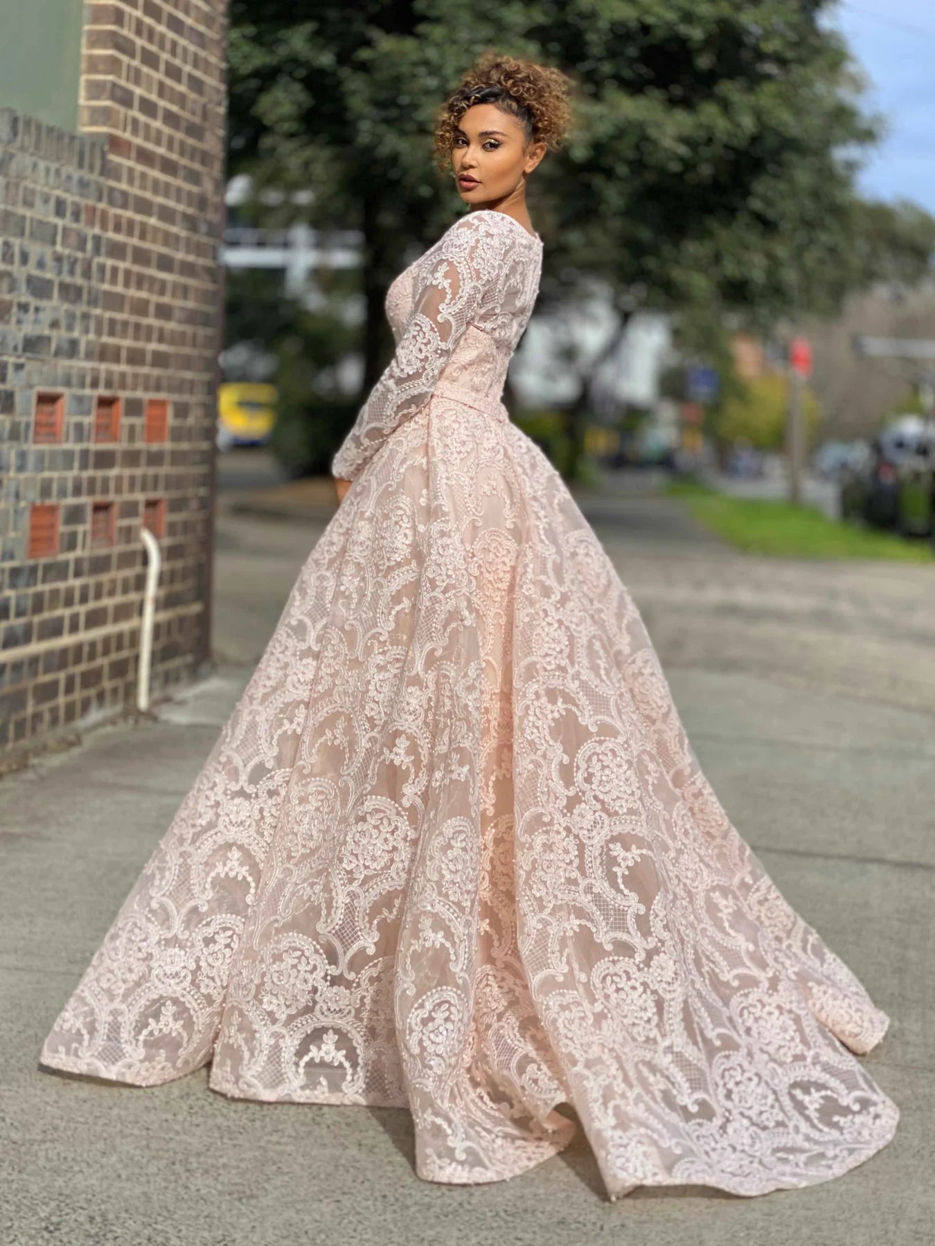 Jadore JX4048 Long Sleeve Lace Evening Gown - A stunning gown featuring long sleeves, a high neckline, intricate lace and beaded detailing, and a big flared out skirt, perfect for any evening occasion.