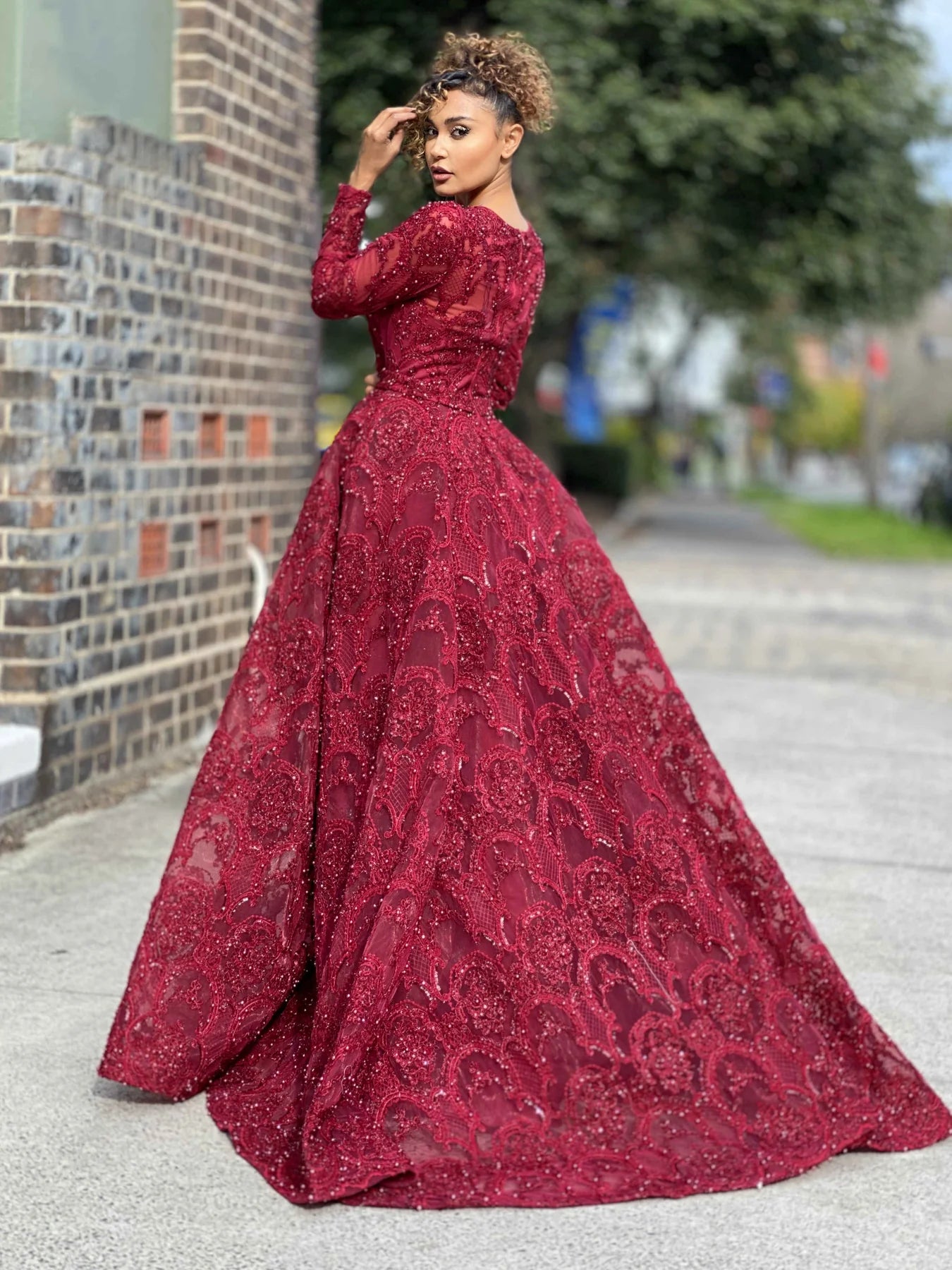 Jadore JX4048 Long Sleeve Lace Evening Gown - A stunning gown featuring long sleeves, a high neckline, intricate lace and beaded detailing, and a big flared out skirt, perfect for any evening occasion.