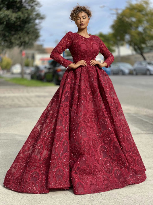 Jadore JX4048 Long Sleeve Lace Evening Gown - A stunning gown featuring long sleeves, a high neckline, intricate lace and beaded detailing, and a big flared out skirt, perfect for any evening occasion.