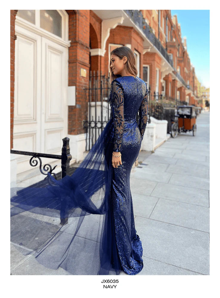 Back view of the sequined Jadore JX6035 gown in ice smoke, featuring sheer detailing and a flowing cape.