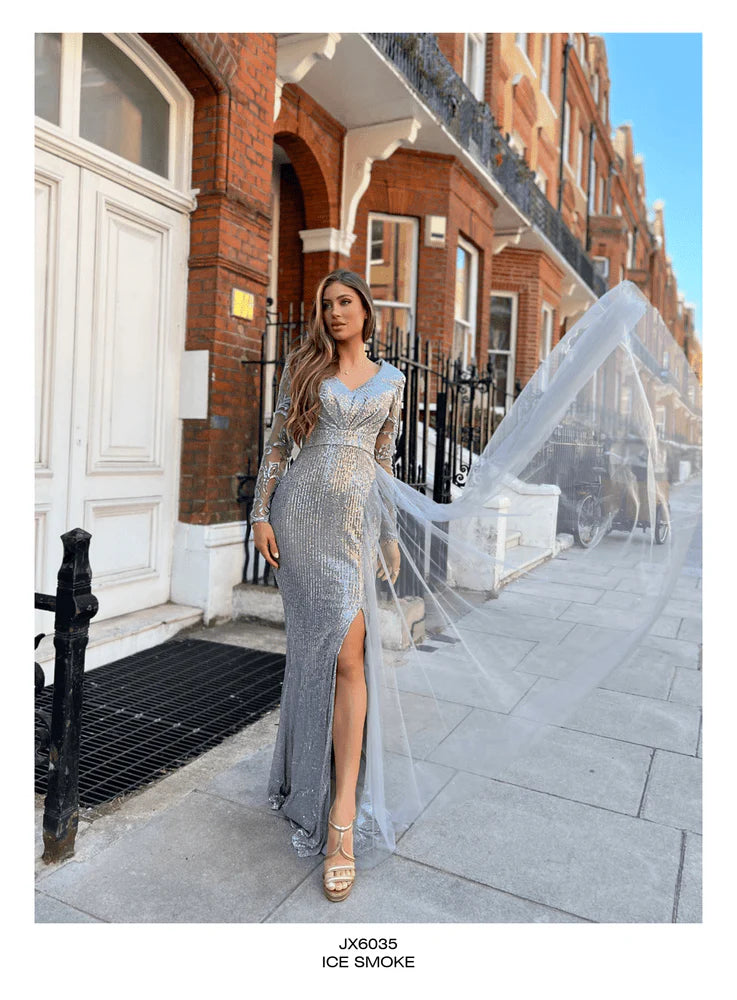 Back view of the sequined Jadore JX6035 gown in ice smoke, featuring sheer detailing and a flowing cape.