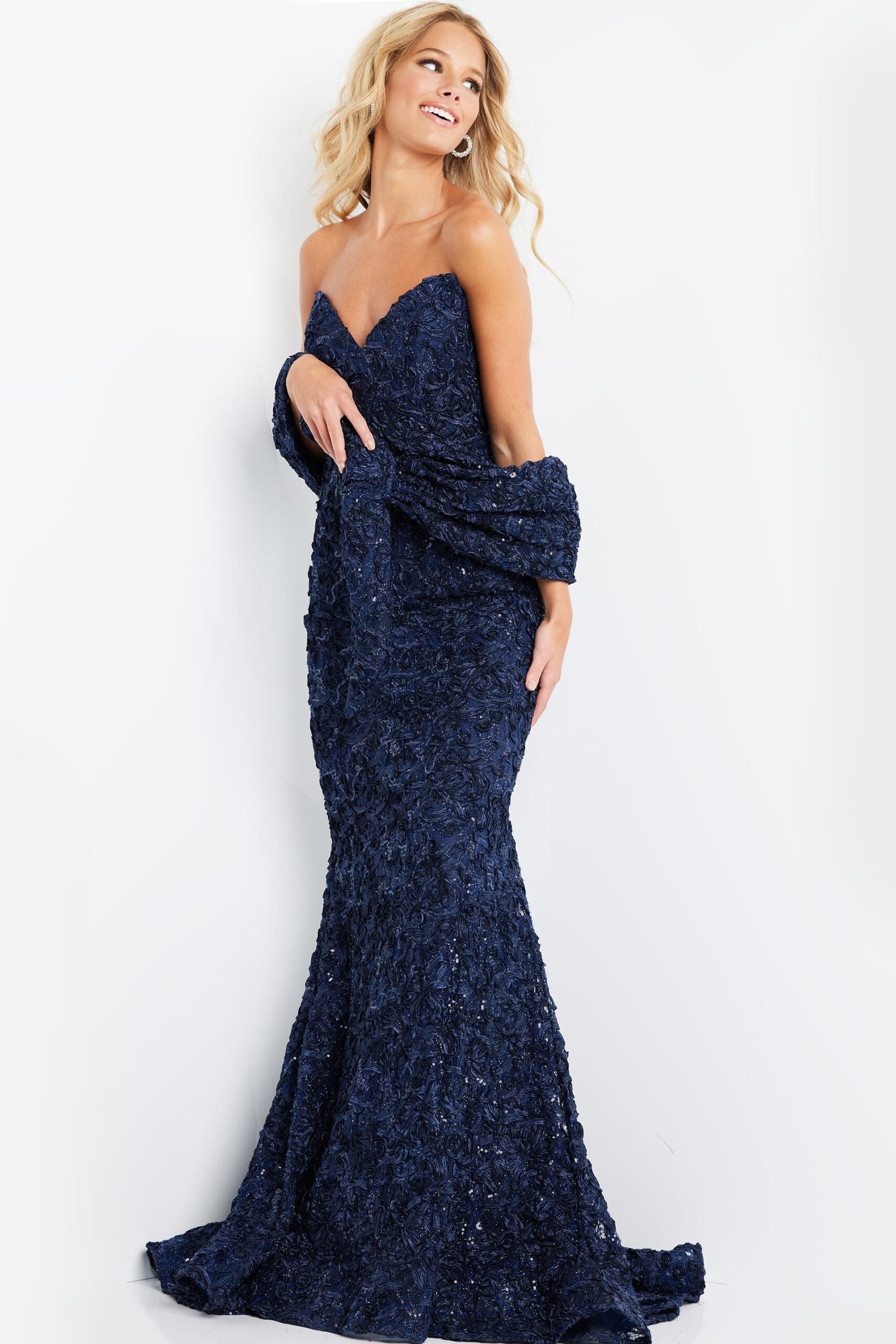 Model wearing Jovani 09768 lace appliqué mermaid gown with sweetheart neckline, matching shawl, and dramatic flared hem.