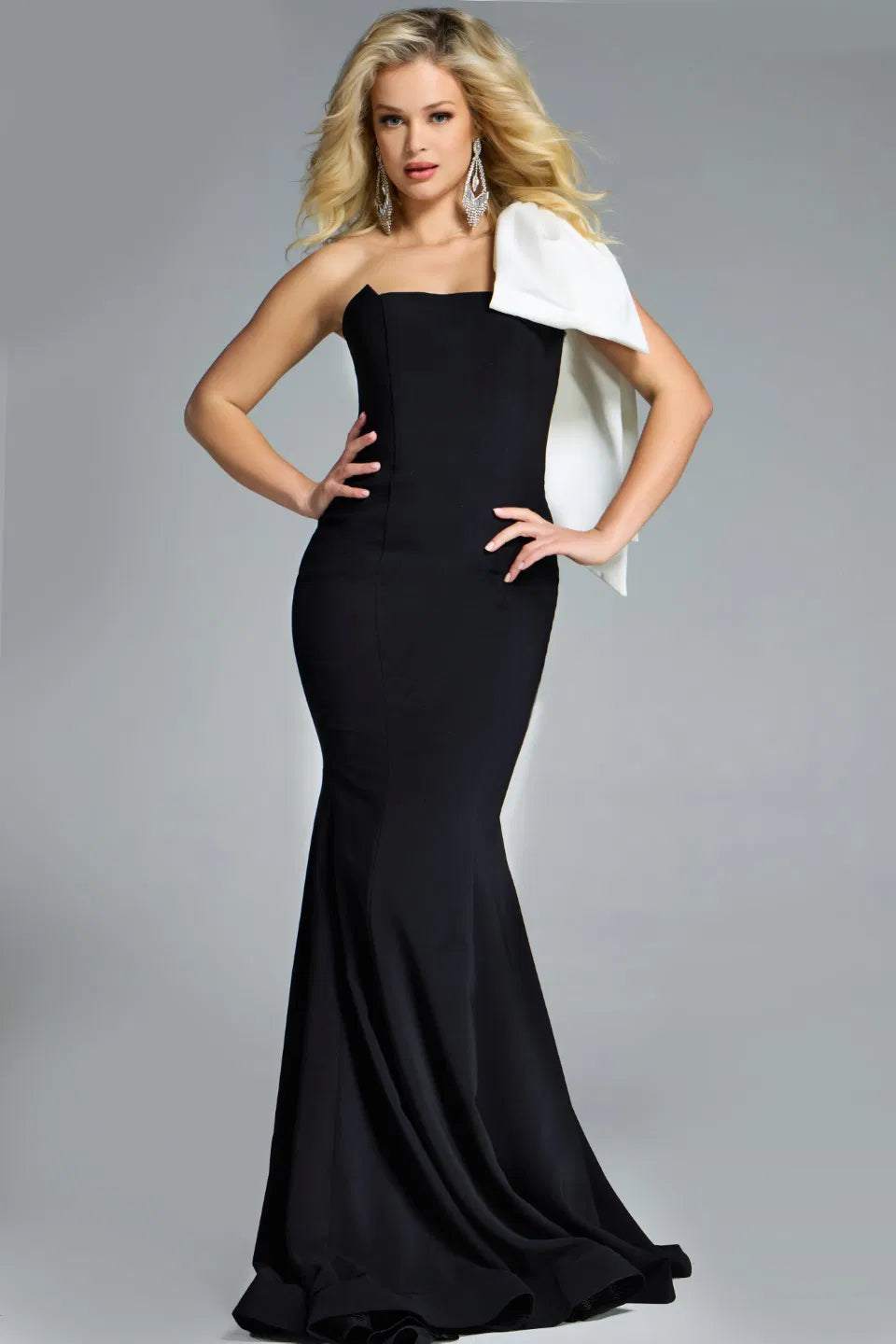 Jovani 41132 Strapless Gown featuring a sleek silhouette, strapless neckline, and a dramatic oversized white bow for formal occasions.