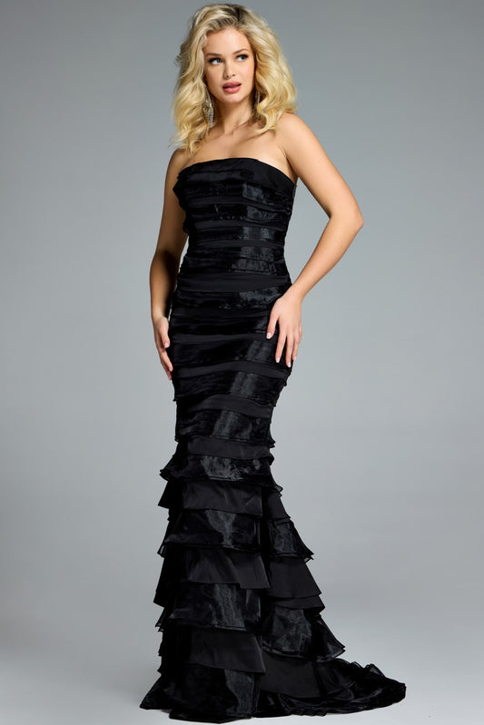 Model wearing Jovani 44383 strapless tiered ruffle gown with fitted silhouette and sweep train.