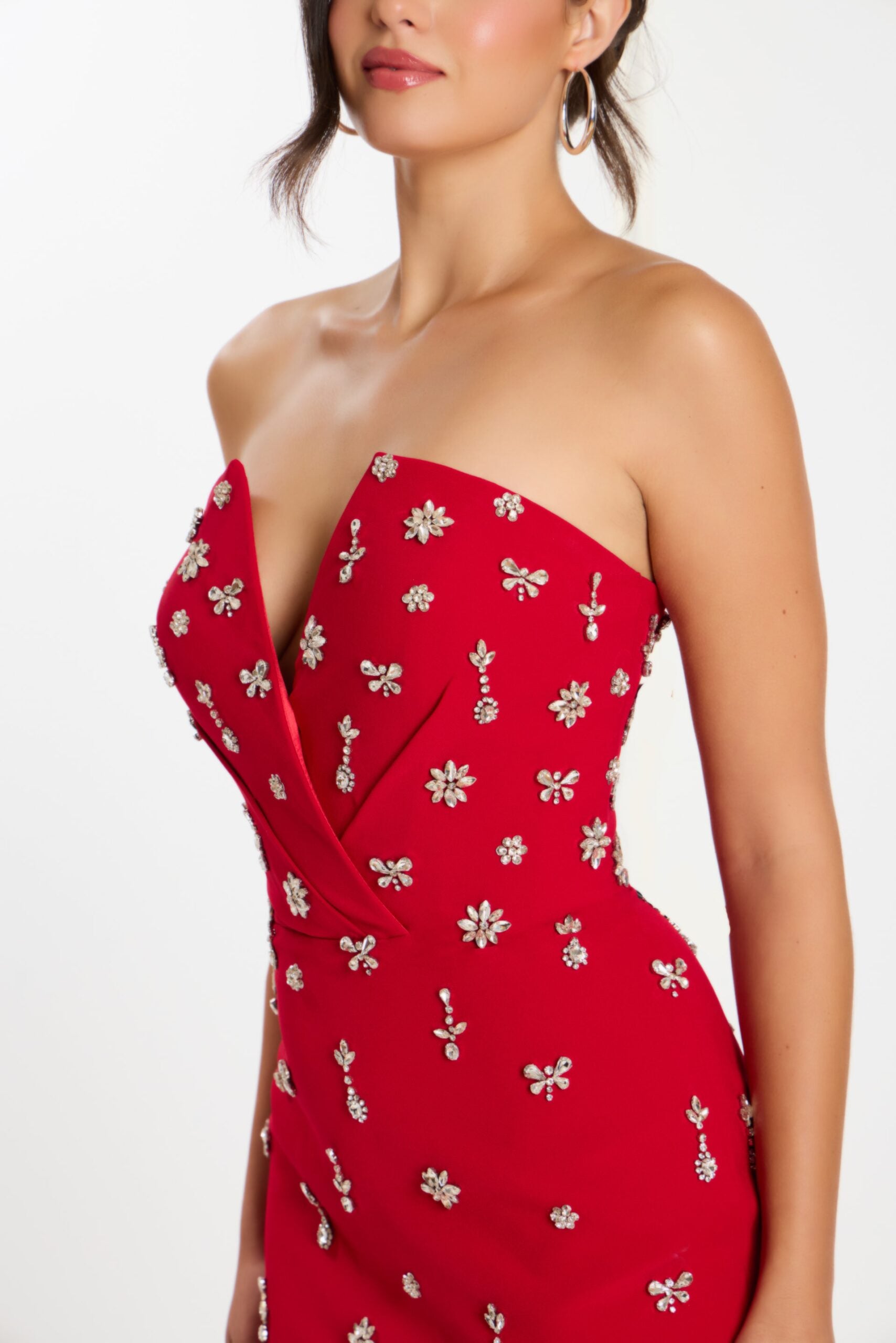 Model wearing Jovani 45249 strapless cocktail dress with intricate embellishments and fitted knee-length silhouette.  Close Up.